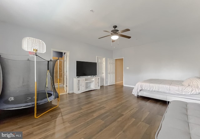 bedroom with dark hardwood / wood-style flooring and ceiling fan