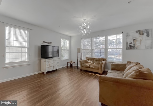 living room with hardwood / wood-style flooring and an inviting chandelier