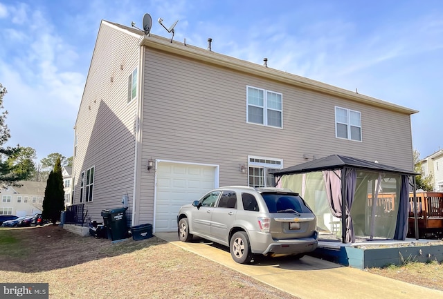 rear view of house with a garage