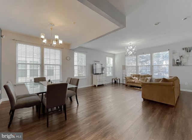 dining space featuring an inviting chandelier, dark hardwood / wood-style floors, and a wealth of natural light