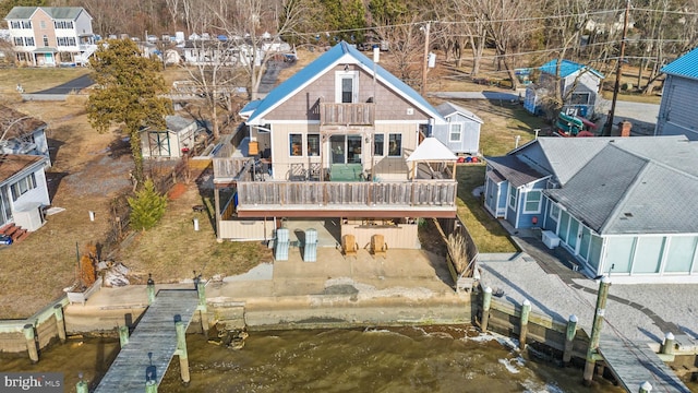 rear view of property featuring a deck and a patio area