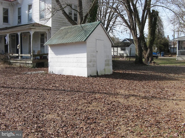 garage with a shed and a porch