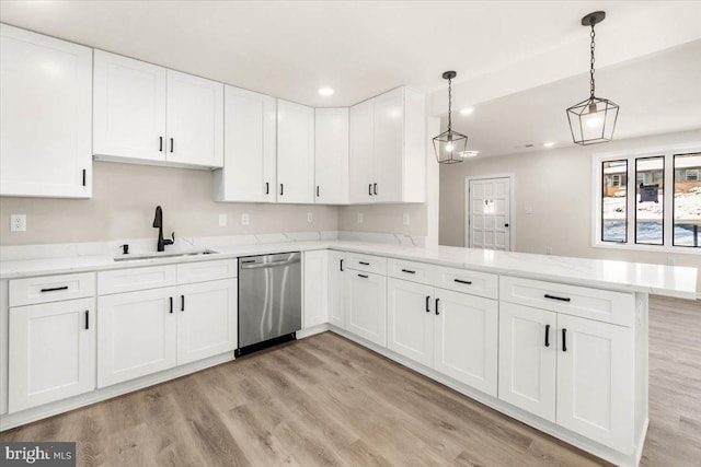 kitchen featuring dishwasher, white cabinetry, hanging light fixtures, sink, and kitchen peninsula