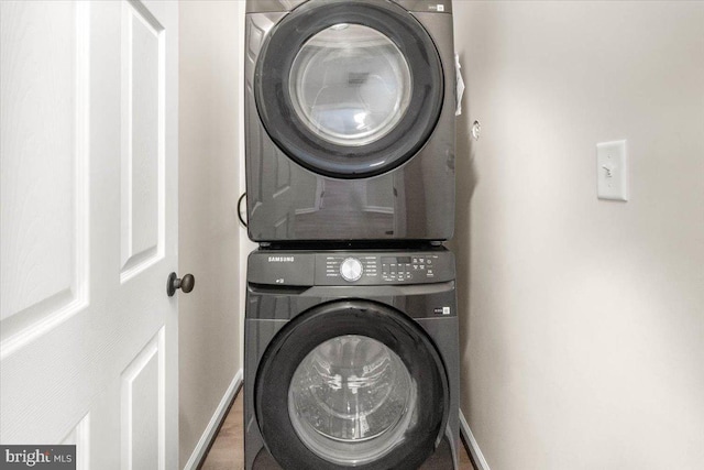 laundry area featuring stacked washer / drying machine