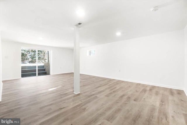 basement with light hardwood / wood-style floors