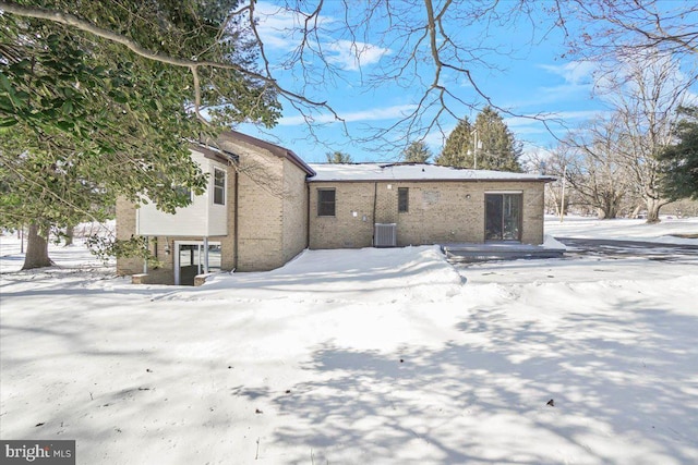 view of snow covered back of property