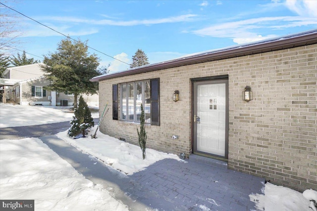 view of snow covered property entrance