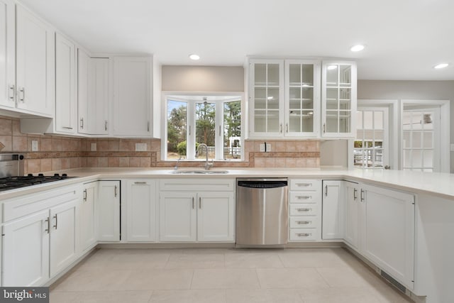 kitchen with backsplash, sink, white cabinets, and appliances with stainless steel finishes