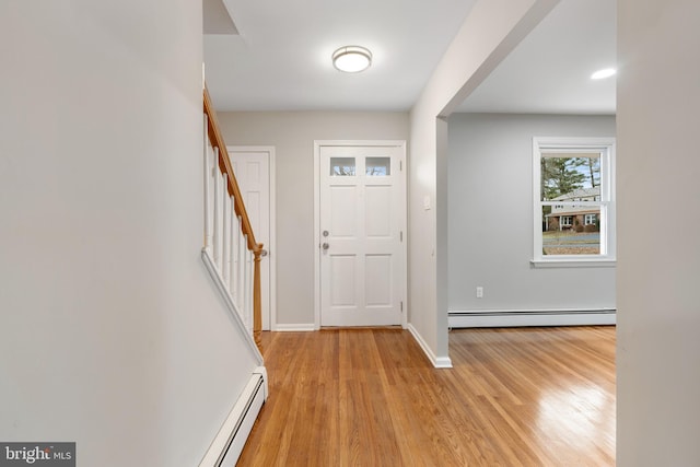 entrance foyer with a baseboard heating unit and light wood-type flooring