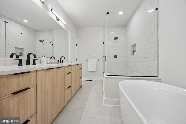 226 N Main St, Doylestown, PA 18901 - bathroom featuring a shower stall, double vanity, a freestanding tub, tile patterned flooring, and recessed lighting