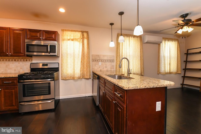 kitchen featuring appliances with stainless steel finishes, a wall mounted air conditioner, sink, decorative backsplash, and kitchen peninsula