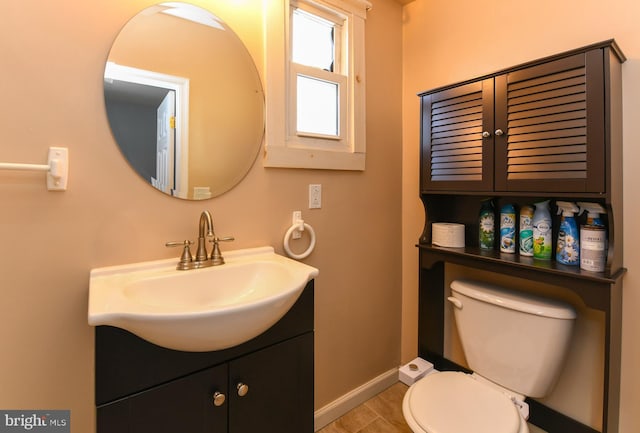 bathroom featuring tile patterned flooring, vanity, and toilet