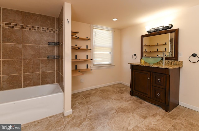 bathroom with tiled shower / bath and vanity