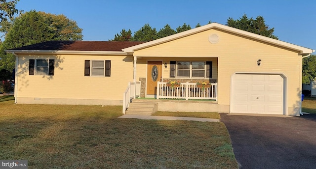 view of front of property featuring a front yard, covered porch, and a garage