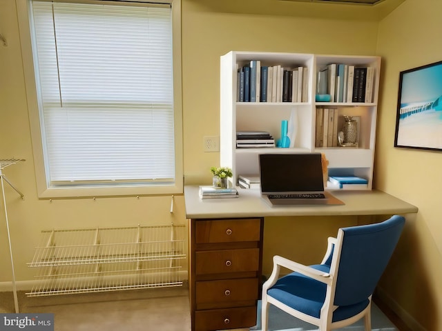 office space featuring carpet floors and built in desk