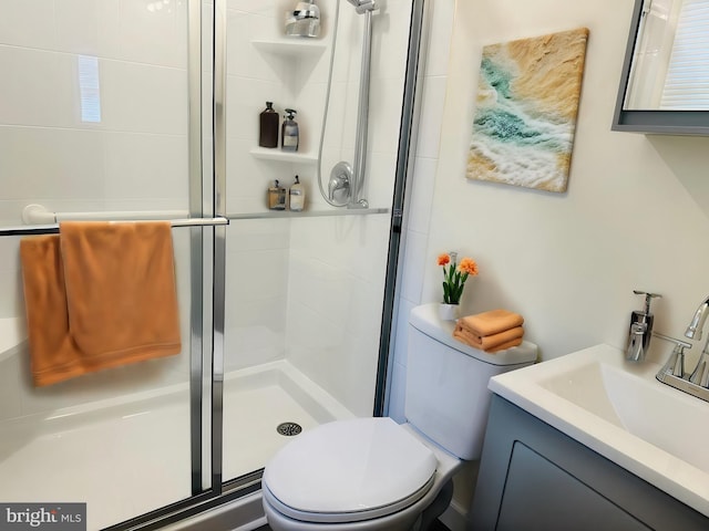 bathroom with toilet, vanity, and walk in shower