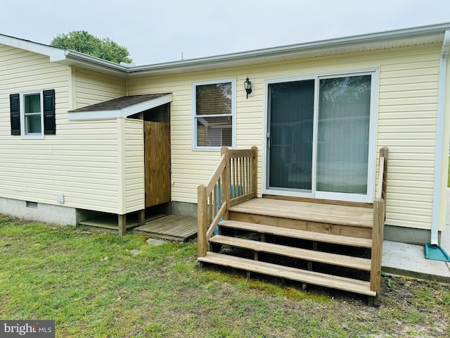 view of exterior entry featuring a yard