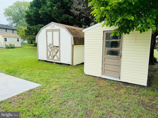 view of outbuilding featuring a lawn