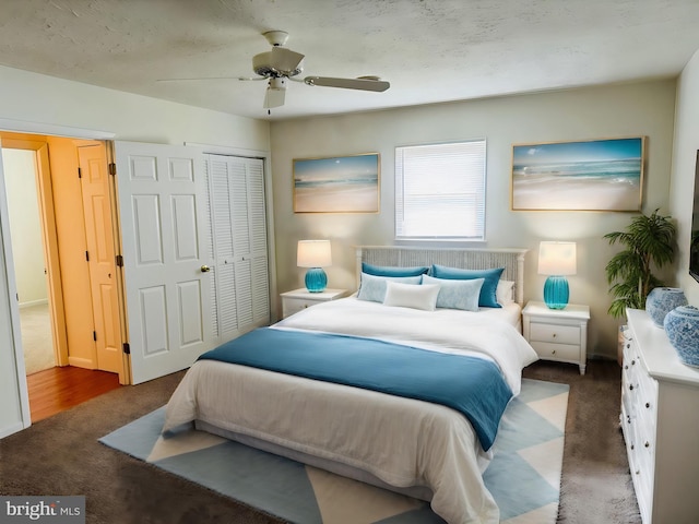 bedroom featuring ceiling fan, a closet, and dark carpet