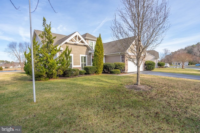 view of front of house with a garage and a front lawn