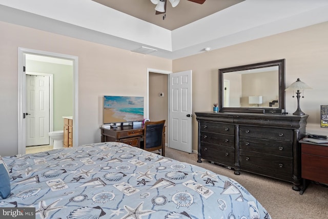 bedroom featuring ceiling fan, ensuite bath, and light colored carpet