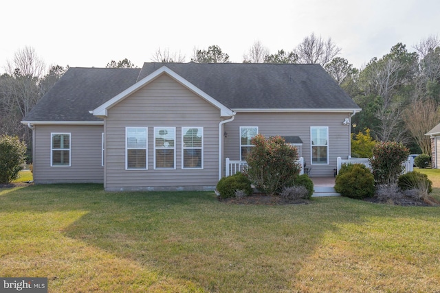 back of house featuring a lawn