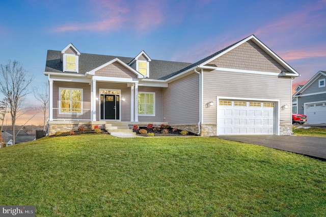 craftsman-style home featuring a garage, a yard, and central AC unit