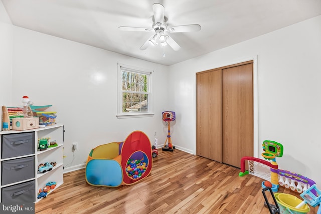 game room featuring light hardwood / wood-style floors and ceiling fan