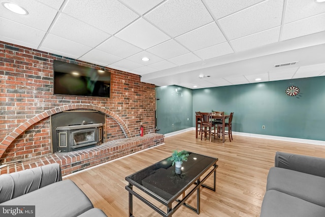 living room with hardwood / wood-style floors and a paneled ceiling