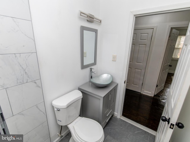 bathroom featuring toilet and vanity