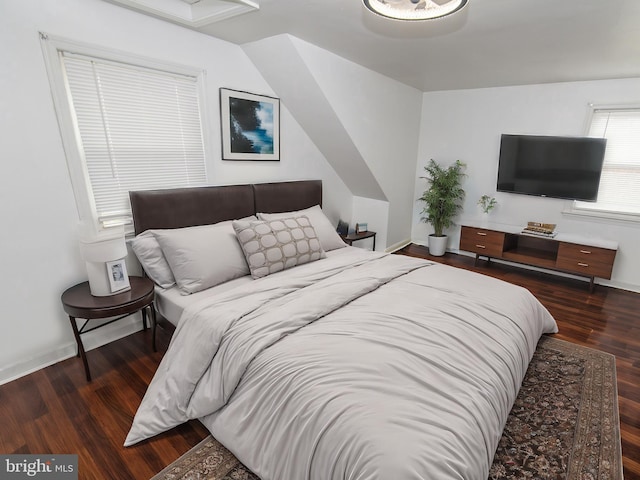 bedroom with dark hardwood / wood-style floors