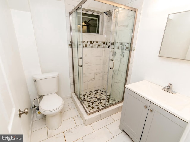 bathroom featuring a shower with shower door, toilet, and vanity