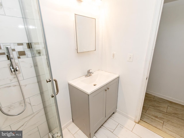 bathroom with an enclosed shower and vanity