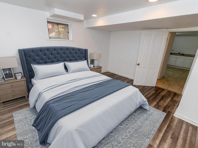 bedroom with dark hardwood / wood-style flooring