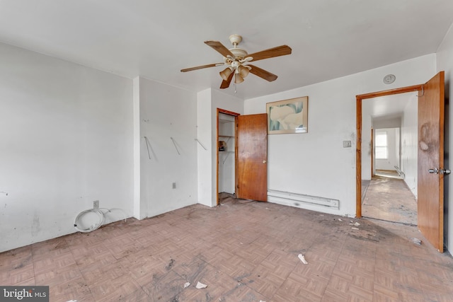 interior space featuring ceiling fan, light parquet floors, and baseboard heating