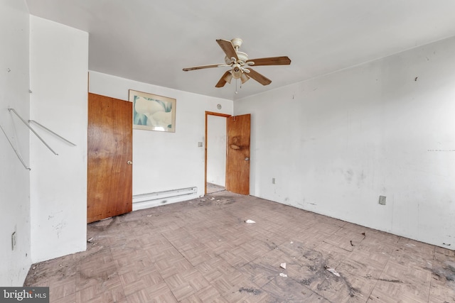 empty room featuring ceiling fan, a baseboard radiator, and light parquet flooring