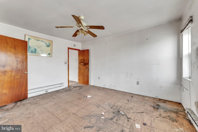 spare room featuring baseboard heating and ceiling fan