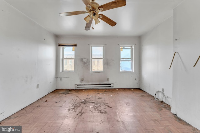 unfurnished room featuring ceiling fan and baseboard heating