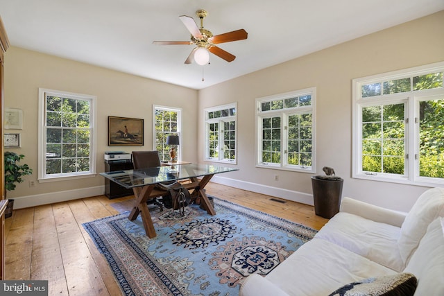 home office with ceiling fan and light wood-type flooring