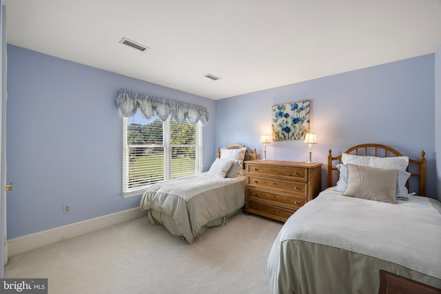 bedroom featuring light colored carpet