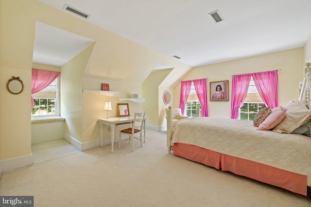 bedroom featuring lofted ceiling and light carpet