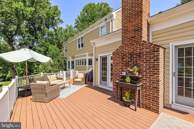 wooden deck with an outdoor living space