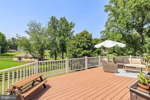 wooden terrace with an outdoor living space and a yard