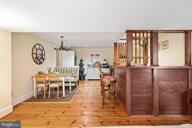 interior space featuring an inviting chandelier and light wood-type flooring