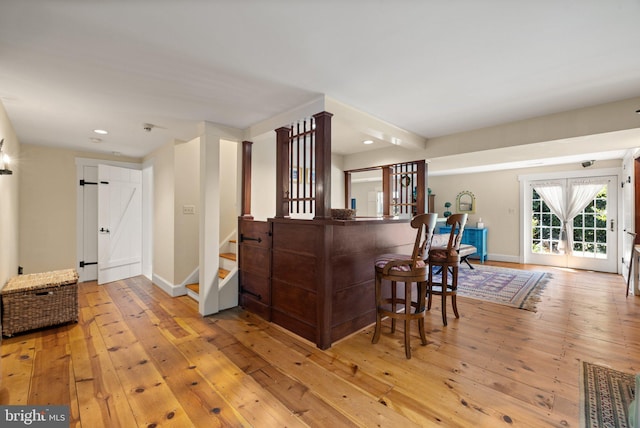 bar with light hardwood / wood-style flooring