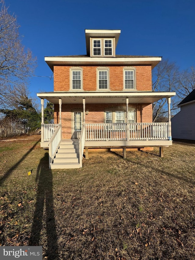 view of front of house featuring covered porch and a front lawn