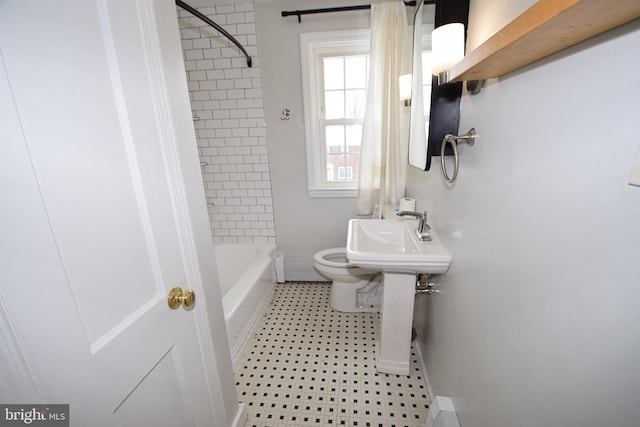 full bathroom with toilet, tiled shower / bath combo, and sink