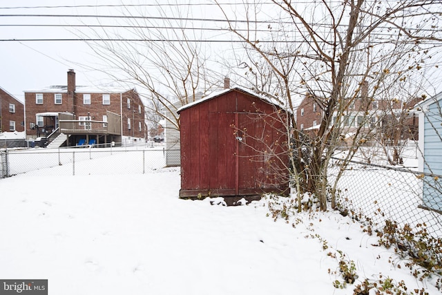 snowy yard with a storage unit