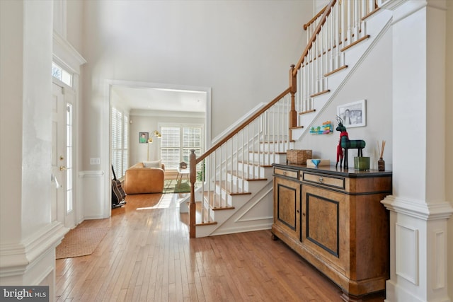 entrance foyer featuring decorative columns and light wood-type flooring