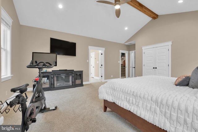 carpeted bedroom with vaulted ceiling with beams and ceiling fan